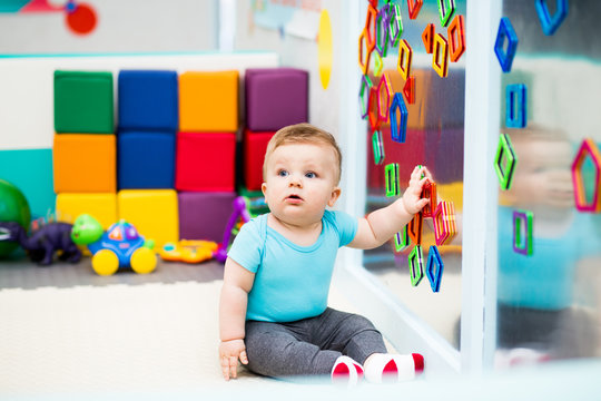 Baby Playing with Colorful Magnets