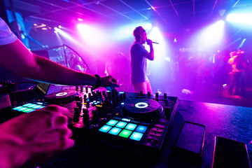 Fototapeta na wymiar artist with a microphone performs on the stage of a nightclub