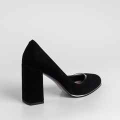 Womens black suede shoes with transparent inserts on a high thick heel. Close-up. Catalog shooting