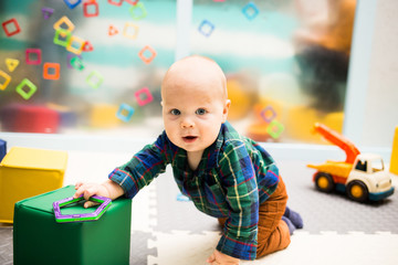Little baby crawling with toys