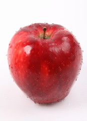 Red apple with water drops isolated on white background.