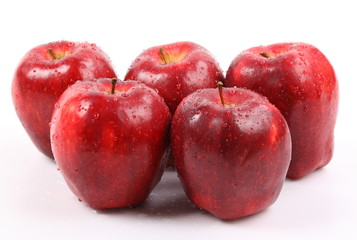 Red apple with water drops isolated on white background.