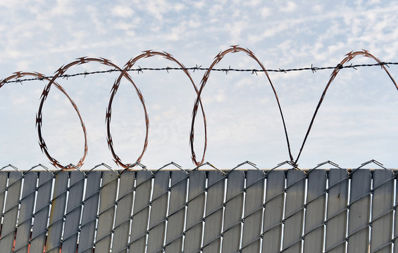 Barb wire fence with razor wire around
