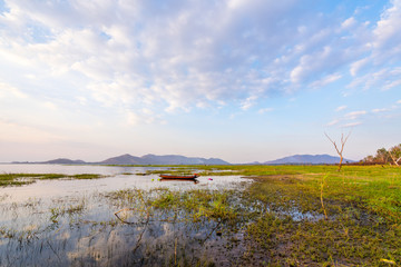 Fototapeta premium Fishing boat with sunset at Bang phra reservoir ,sriracha chon buri, thailand