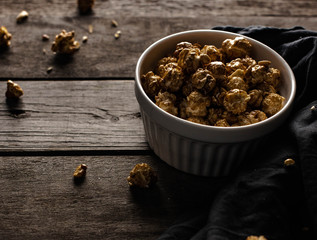 popcorn in a bowl, sweet popcorn, sweet snack, dessert, popcorn on a wooden background, crumbs from dessert