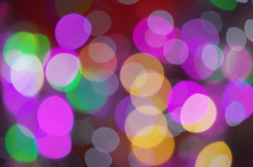 Celebratory background from multi-colored circles. Defocused shooting of colored light sources.