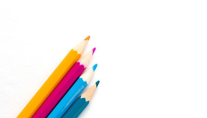multicolored pencils on the album sheet in the corner