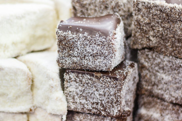 Pieces of fresh baked cake with icing, chocolate and desiccated coconut