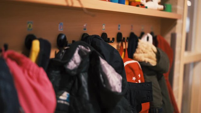 Slow shot of some children&rsquo;s jackets at a school /daycare.