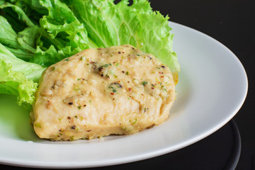 Chicken breast steak with spices serve with fresh green lettuce on white plate. High protein food. Healthy for loose weight.