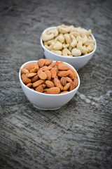 Almonds and Cashews in white bowls 
