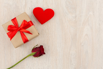 Valentine's Day Concept Gift box, heart and red rose on the wooden table