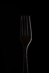 White contour fork on black background.