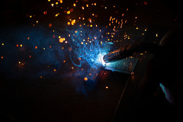Metal welding. Sparks from electric heating. Work in the workshop. Creation of reliable fastening...