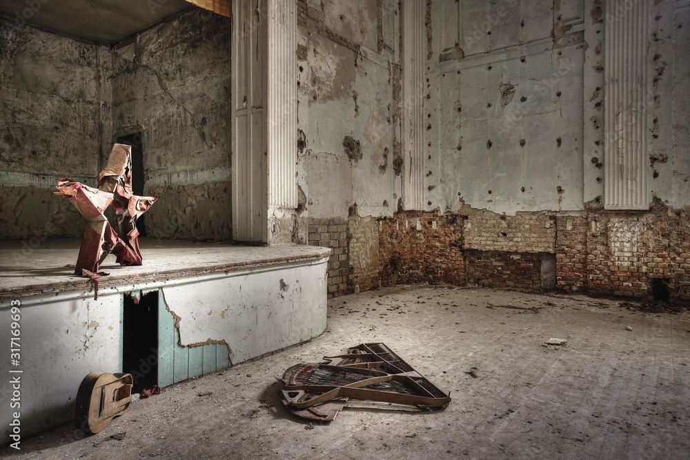 Poster old musical instruments inside an abandoned building with rusty walls