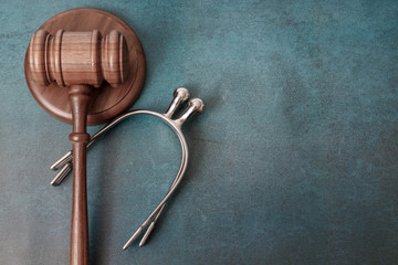Equine horse equestrian law comcept gavel and spurs on blue background - obrazy, fototapety, plakaty