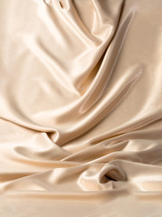 Abstract white wavy textile silk background with milky, creamy, champagne color