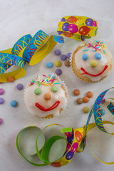 Fototapeta na wymiar carnival clown muffins decorated with multi colored chocolate lentils