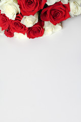Bunch of red and white roses on blank surface with copy space for text. Backdrop for Saint Valentine's Day, International Women's Day, Mother's Day. Romantic greeting card, poster, invitation template