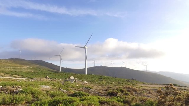 eolic turbine wind renewable energy farm on top of mountain 4k