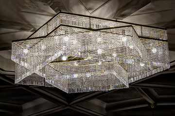 A large beautiful crystal chandelier of square shape.