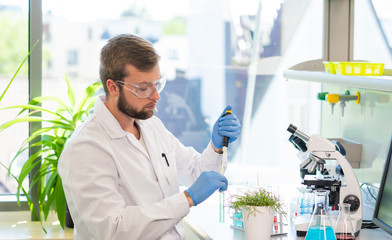 Scientist working in lab. Doctor making microbiology research. Laboratory tools: microscope, test tubes, equipment. Biotechnology, genetics, biochemistry, pharmaceutical, dna and health care.