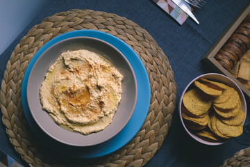 Hummus dipping sauce served with toasts on a tableware