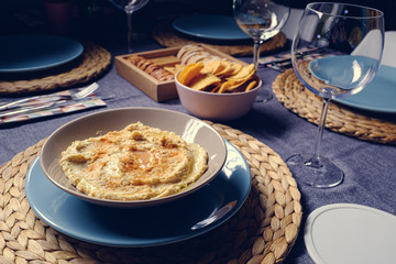 Hummus dipping sauce served with toasts on a tableware