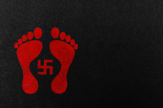 Swastik Design with Red Lakshmi footprints. Dhanteras concept
