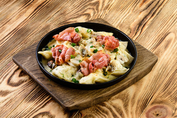 homemade dumplings with bacon in a pan