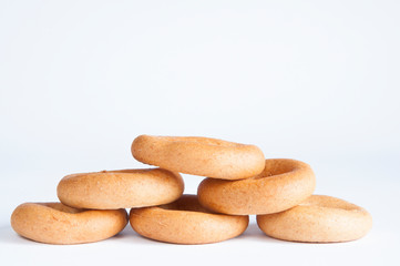 Delicious dried pastries stacked in a pile on a table on a white background.