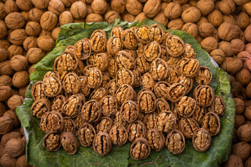 Walnuts in shell heap pattern as organic food background