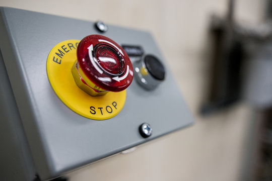 Big Red emergency button or stop button for manual pressing. STOP button for industrial equipment, emergency stop. Red light. At the factory and industrial facility
