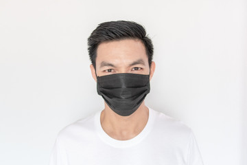 Portrait of young Asian Man wearing mask protect fine dust in air pollution environment
