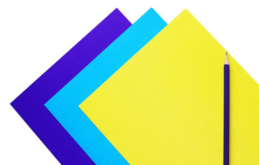 blue, cyan and yellow sheets of paper and pencil, copy space