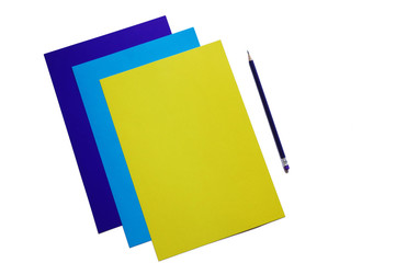 blue, cyan and yellow sheets of paper and pencil, copy space