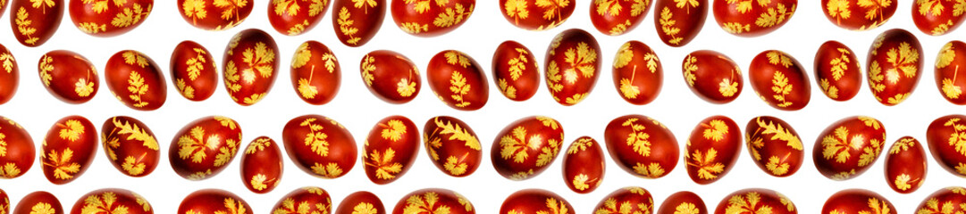 Seamless pattern of Easter eggs dyed with onion husks with fresh leaf imprints isolated on white background. Banner. Creative decoration. Easter traditions concept. Close-up