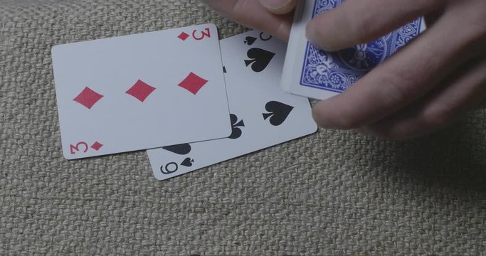 Close-Up Male Hands Lying Playing Cards On A Burlap At Night In The Lantern Light. Dealer Hands Out Cards. Cinema 4K Video