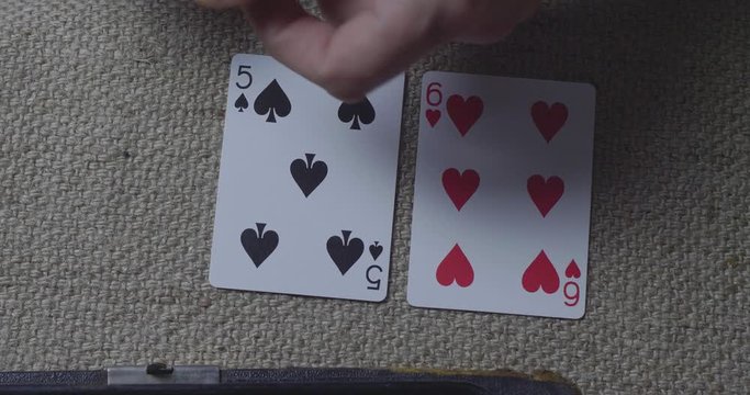 Close-Up Male Hands Lying Playing Cards On A Burlap At Night In The Lantern Light. Dealer Hands Out Cards. Cinema 4K Video
