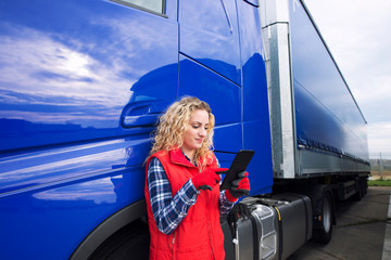 Professional truck driver setting up navigation for destination. Checking his route on tablet...