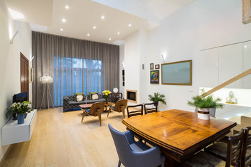 Modern interior of living room in private house. View of wall with big window. Furniture.