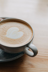 cup of cappuccino on a wooden