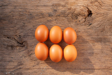Top view 6 eggs on wooden background.