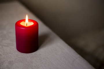 Obraz na płótnie Canvas Red burning wax candle.
