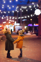 Children girls sisters on city street together