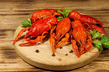 Boiled crayfish on cutting board on wooden table