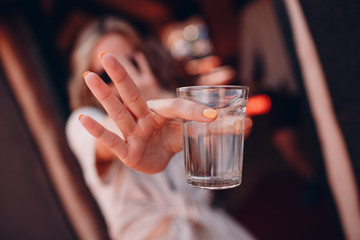 Girl holds out an empty glass