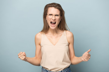 Emotional woman show strength and power screaming with joy