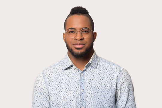 Headshot of black male in glasses isolated on grey background