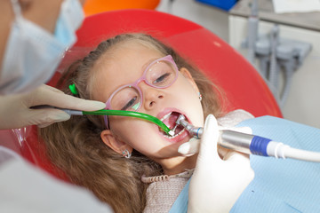 A child with a dentist in a dental office.